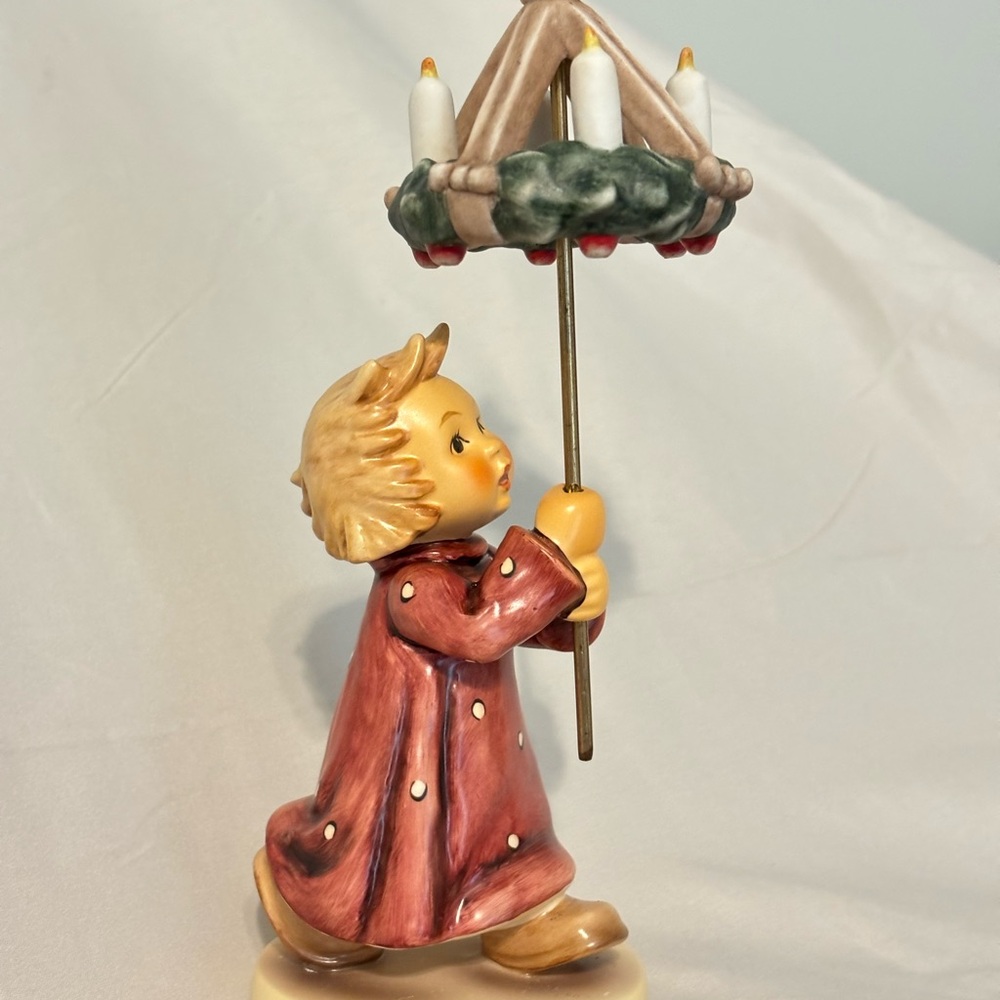 Hummel Figurine with Red and Cream Details Christmas by Candlelight.